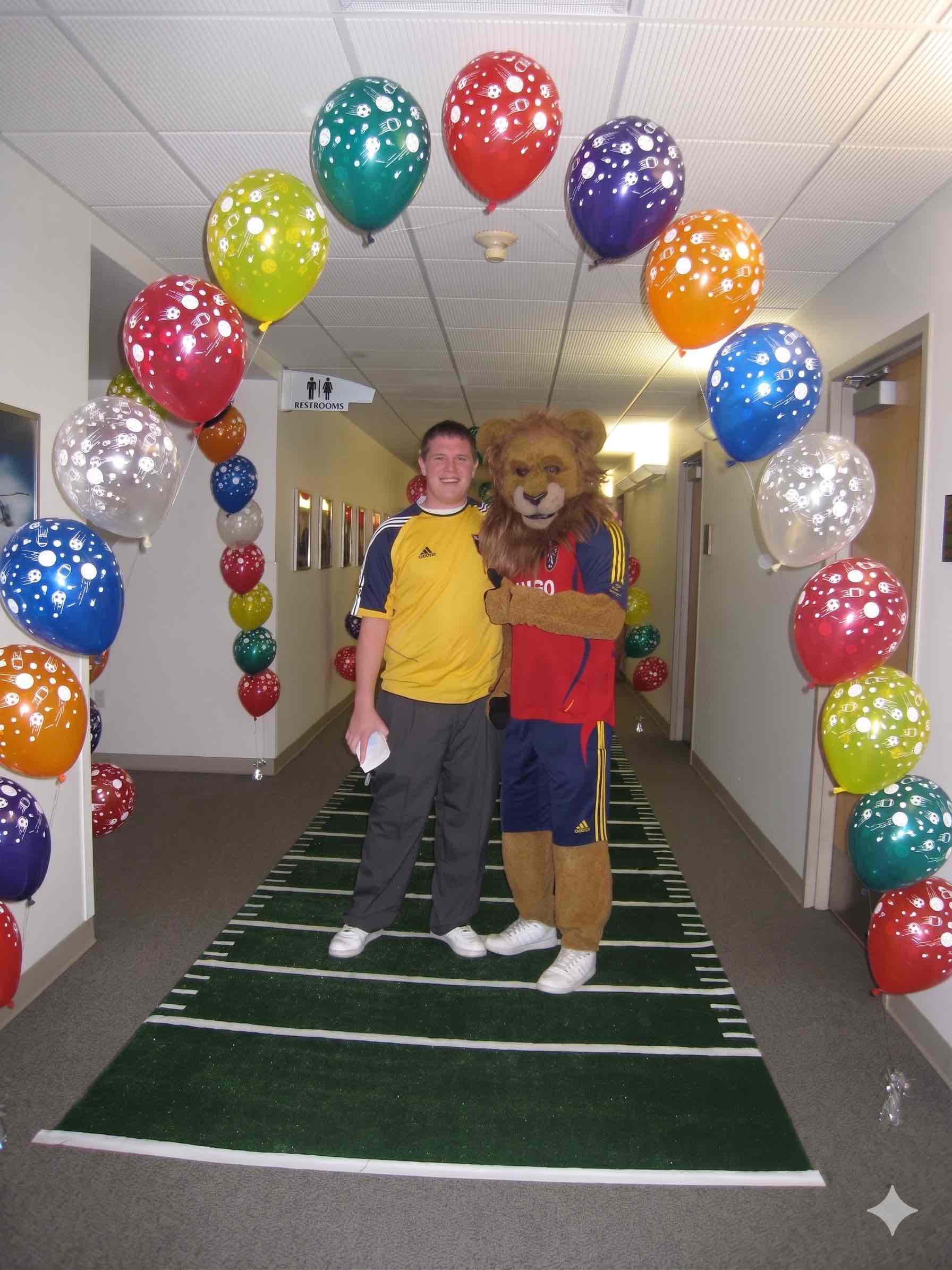 Real Salt Lake mascot beneath a balloon arch